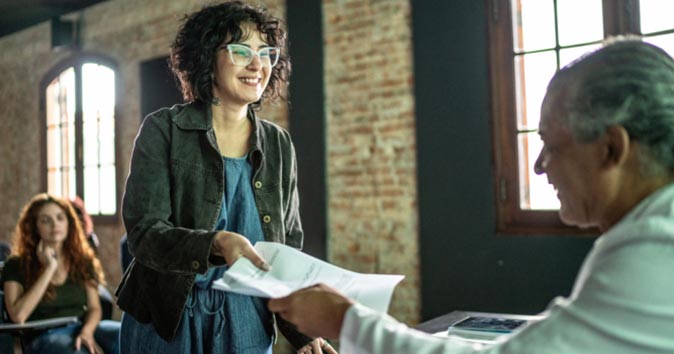 women handing out the paper to other