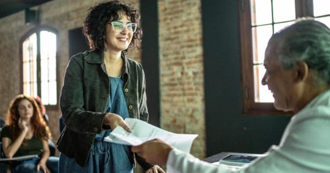 women handing out the paper to other