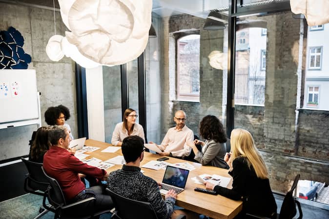 a weekly team meeting in a conference room