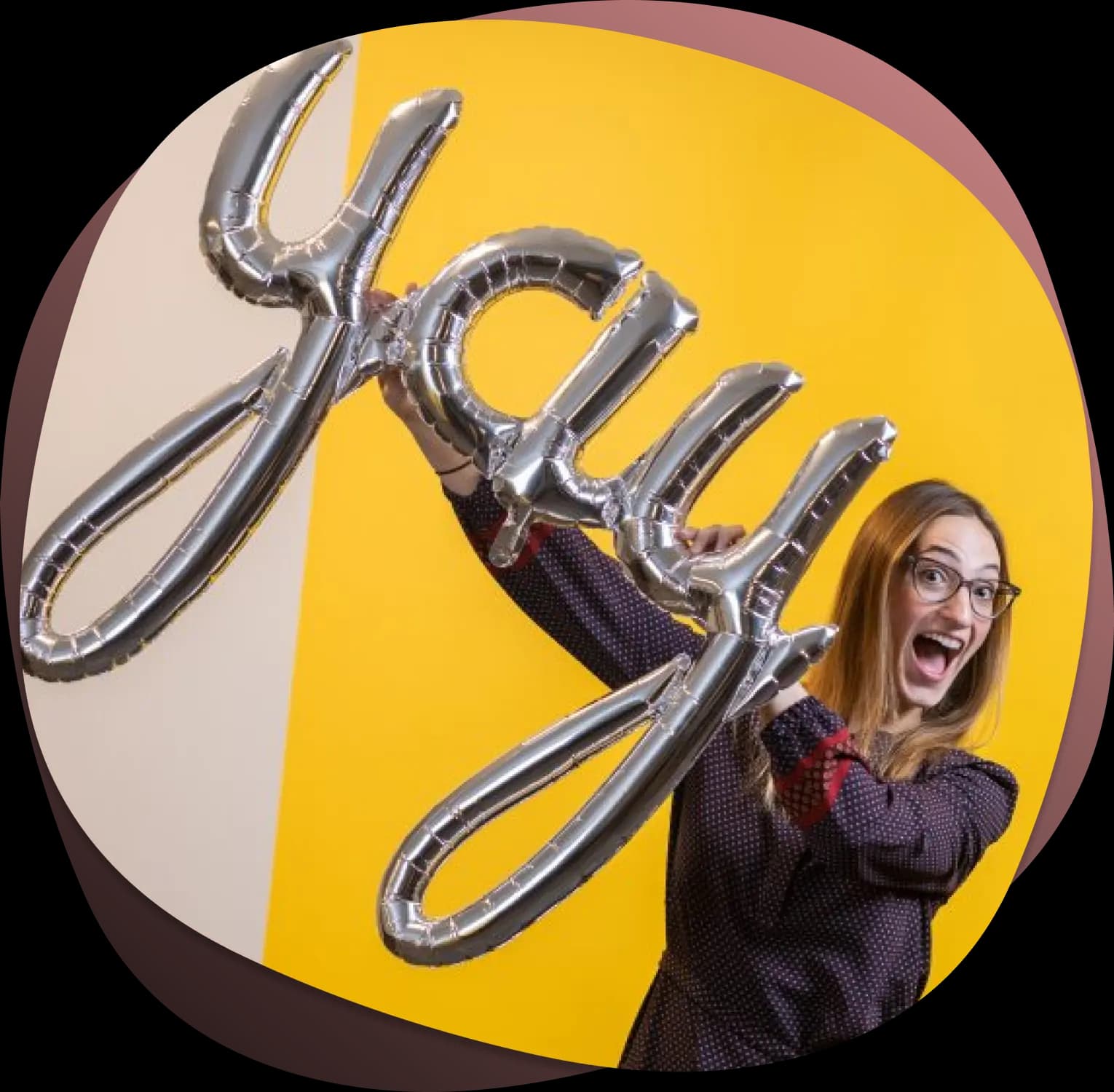 woman holding yay balloon