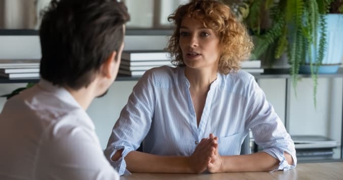 Two people talking in a serious manner.