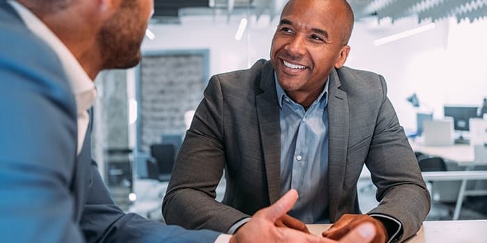 two business men discuss strategic goals for employee performance