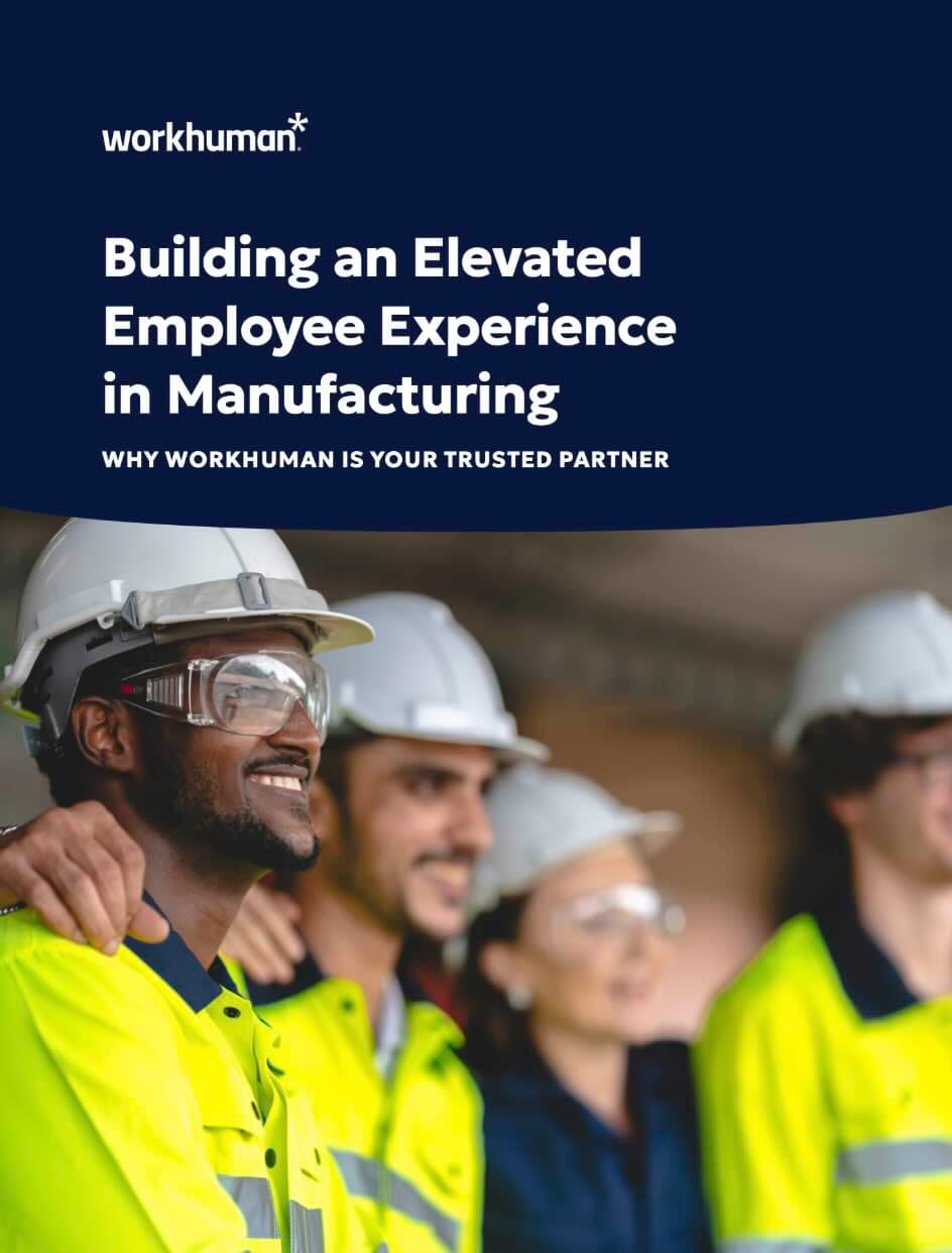 A group of four construction workers wearing safety gear, including fluorescent yellow shirts and hard hats, are smiling together. They are standing closely, with one of the men in the front smiling broadly. A text overlay at the top reads "Building an Elevated Employee Experience in Manufacturing" and a subheading states, "WHY WORKHUMAN IS YOUR TRUSTED PARTNER," accompanied by the Workhuman logo. The background appears to be a construction site.