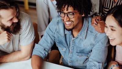 Man smiling with people around him