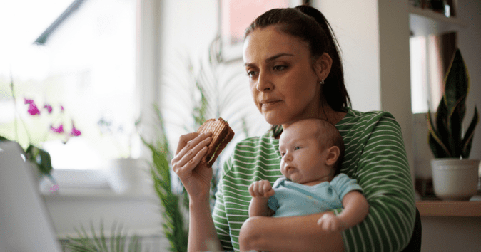 mom eating with baby while working