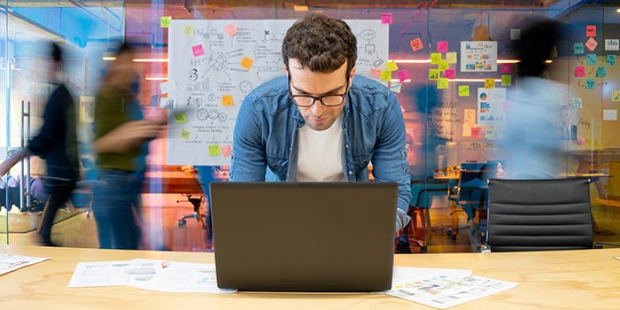 man focused on finding solution during team productivity meeting