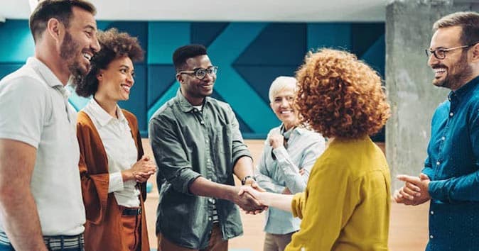 group of people talking and shaking hands