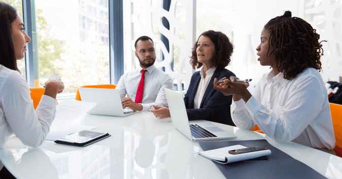 hr team discuss wellbeing and employee experience strategy