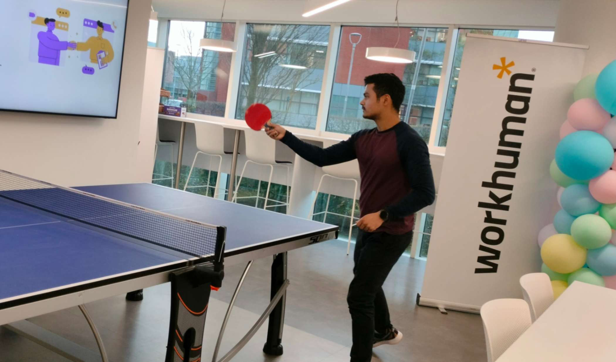 Male playing table tennis in Workhuman office