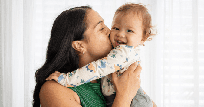 mom kissing baby