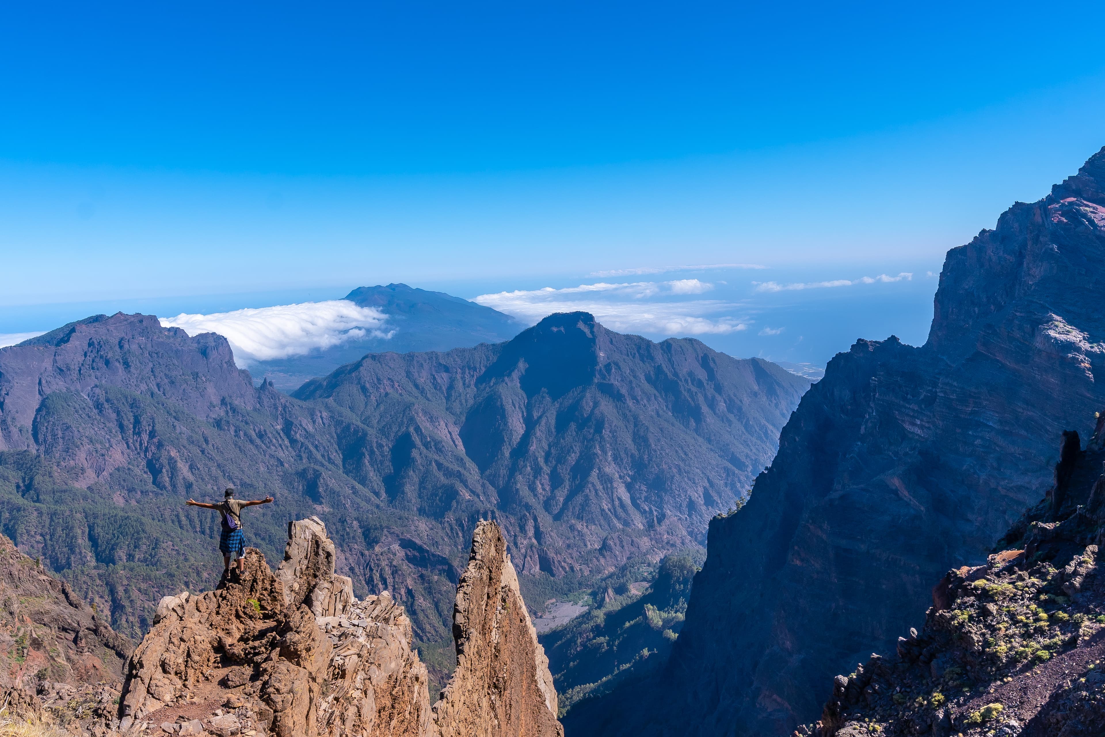 Young man at the summit of a mountain