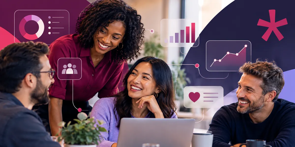 A woman in a burgundy shirt smiles while leaning over a laptop, engaging with three other individuals sitting around a table. Graphical elements, including a bar chart and icons representing people and hearts, are overlayed in the background.