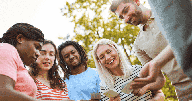 a team playing with cards as it's the most popular outdoor team building activities
