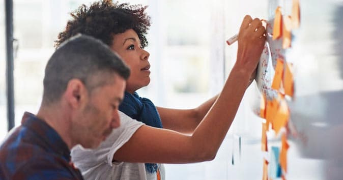 women writing on the whiteboard