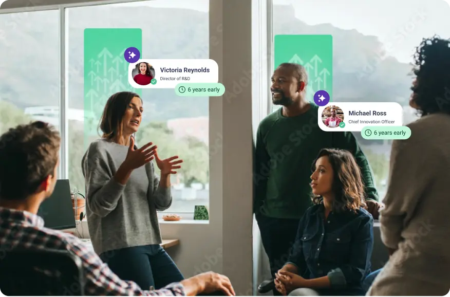 A group of four people is engaged in a discussion in a bright, modern office setting. A woman in a gray sweater, Victoria Reynolds, is speaking animatedly, gesturing with her hands. Two men, one standing to her left and another seated, listen intently. The standing man, Michael Ross, is smiling. A third woman, sitting in front, looks engaged with the conversation. In the background, there are large windows showing a scenic view, and digital green arrows are projected on the glass, suggesting growth or progress. Above the two main speakers are labels indicating their names and positions, along with a note that both have been recognized for being "6 years early" in their roles.