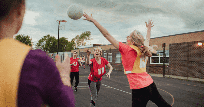 Female netball team enjoying the fun motivational game
