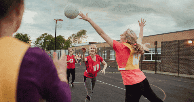 Female netball team enjoying the fun motivational game