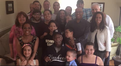 group photo of many smiling men, women and children