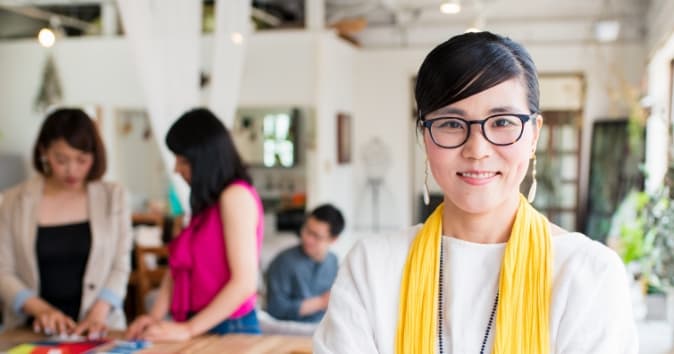 Woman in an office looking towards the camera.