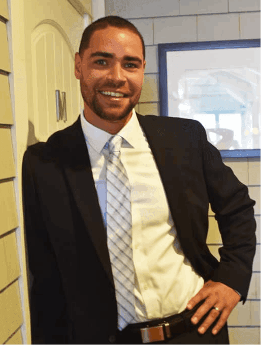 Miguel in suit with white shirt and blue tie