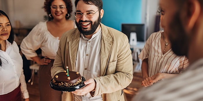 people celebrating a birthday with cake