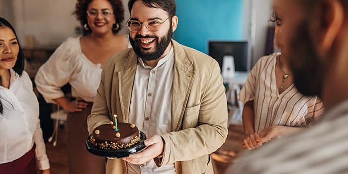 people celebrating a birthday with cake