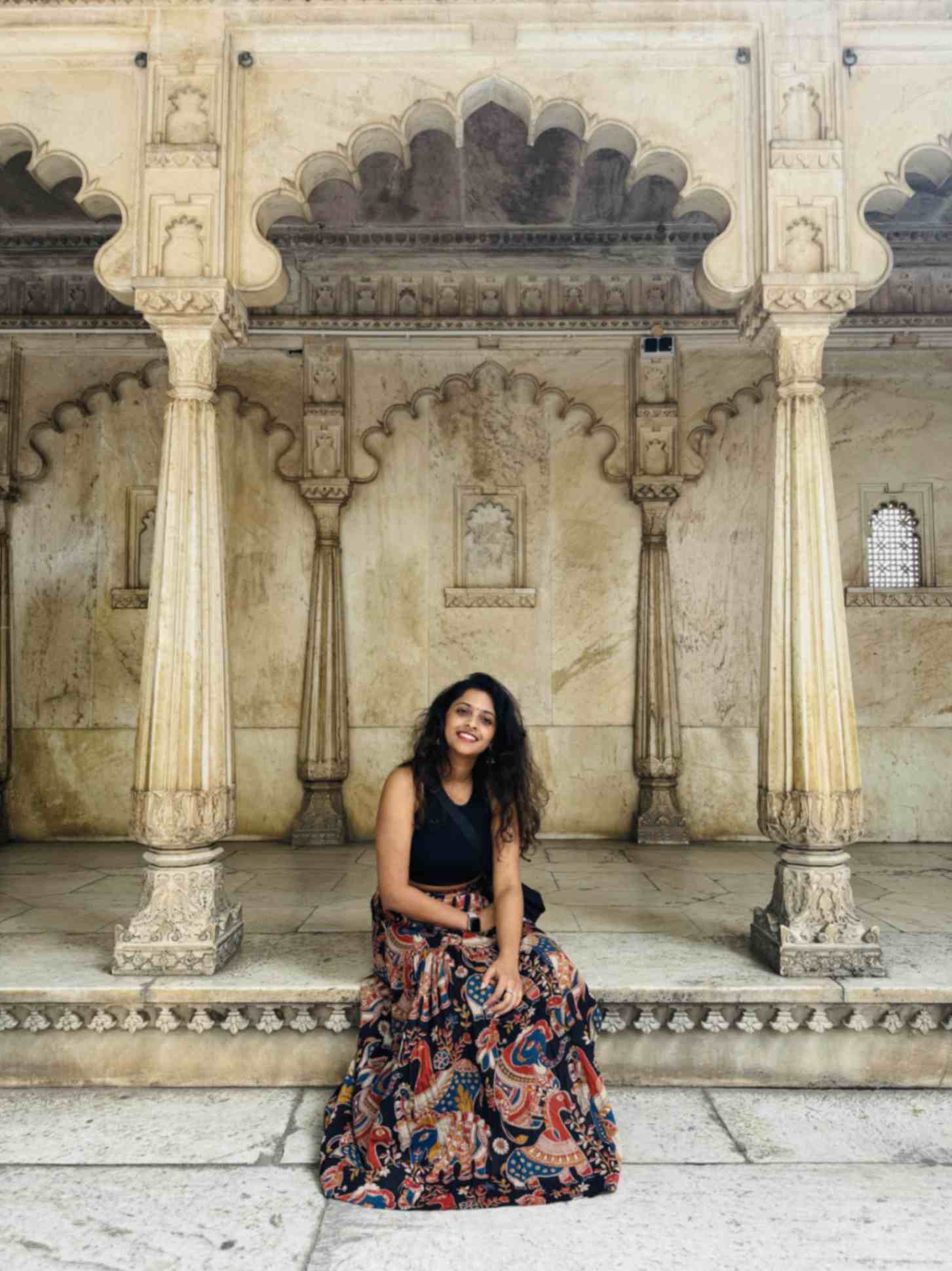 sharanya-sitting-on-a-step-whilst-travelling
