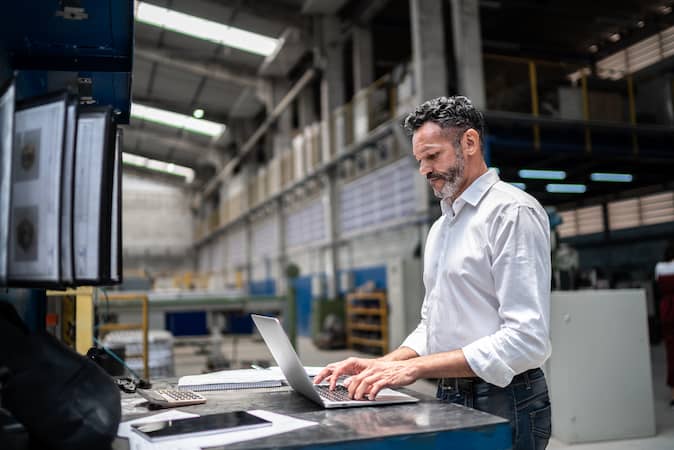 An executive uses EPM solutions via enterprise performance management software to plan and budget operations