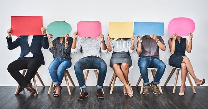 Employees holding dialogue cards