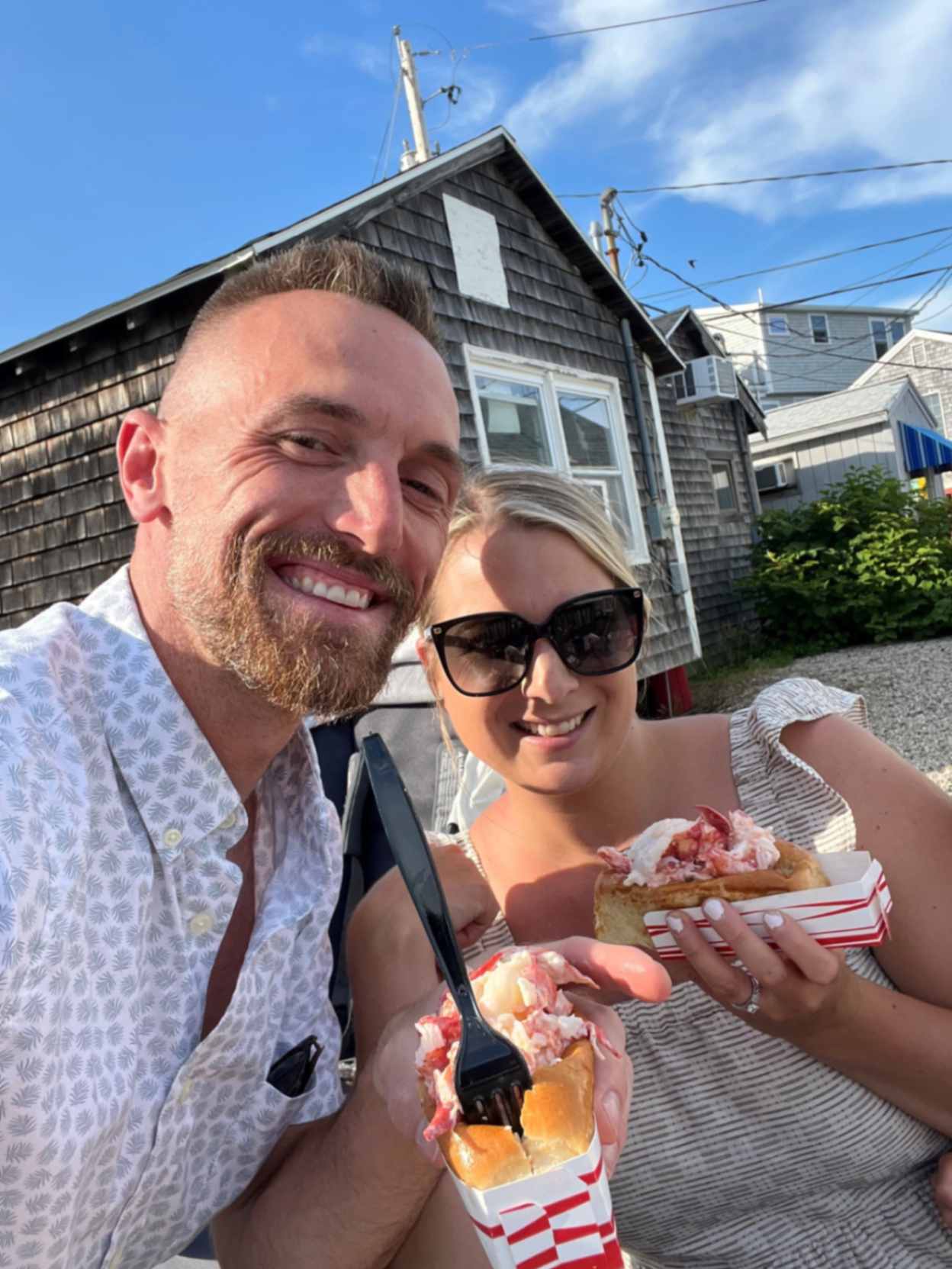 Ashley with husband eating lobster rolls
