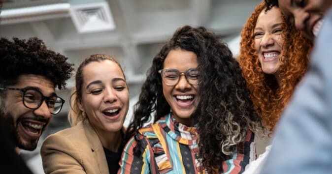 Group of diverse people smiling and celebrating.