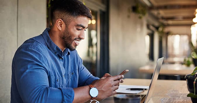 An employee looking into his phone