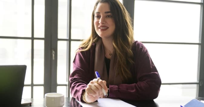 An employee engaged in office housework tasks with a positive attitude.