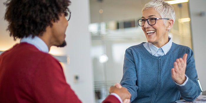 man and a woman shaking hands and smiling