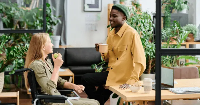 Employees in a green office discuss more sustainable ways to work and save energy