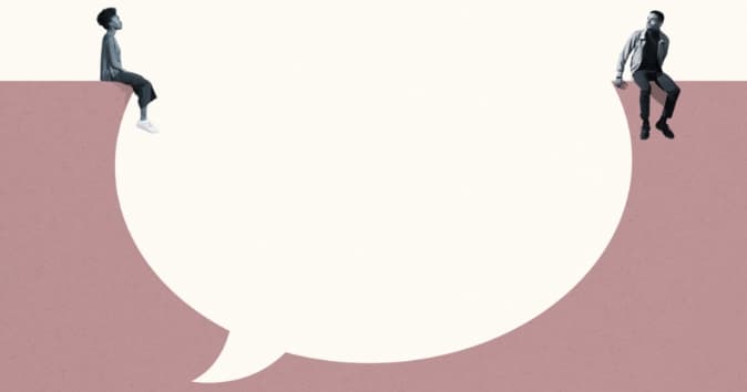 Two people sitting on a giant speech bubble.