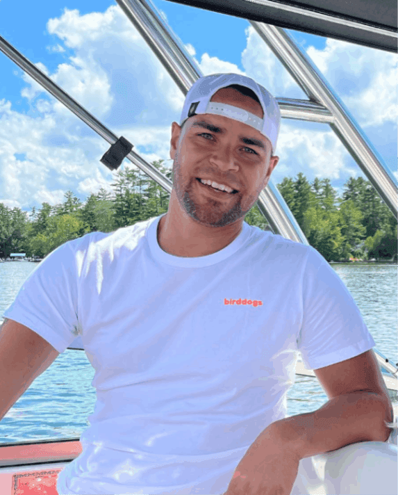 Headshot of Miguel- author of blog on a boat in water