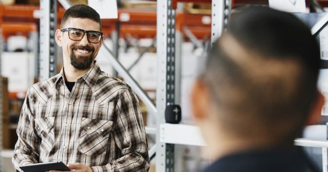 Man smiling toward other people.