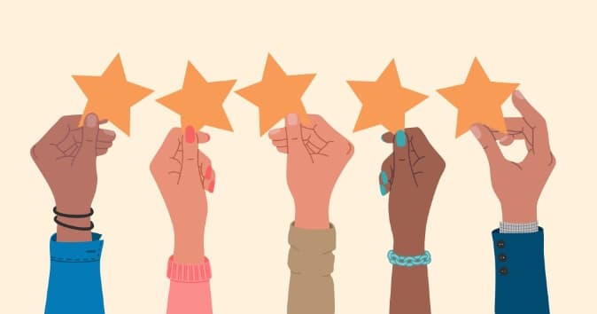 A row of diverse hands each holding up an orange star against a light background. The hands display different skin tones and accessories, symbolizing recognition and celebration.